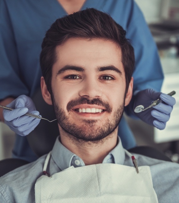 Man smiling in treatment chair at periodontal office in Corpus Christi
