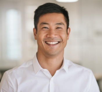 Man smiling in white button down shirt