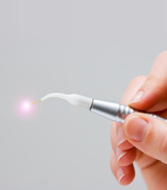 Hand holding soft tissue laser dentistry tool