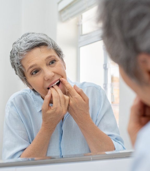 Woman flossing her teeth