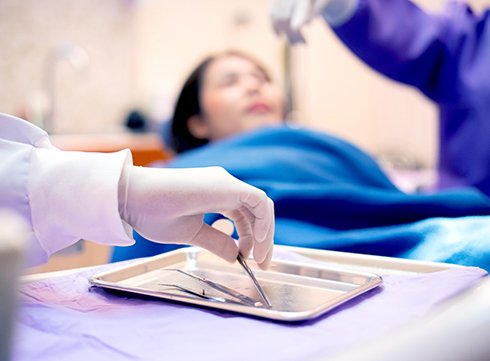 dentist cleaning patient’s teeth