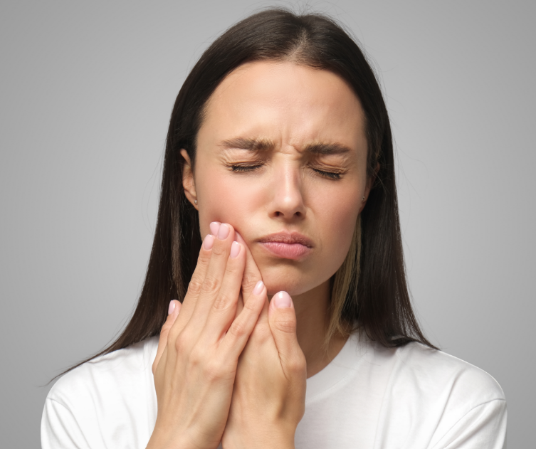 Woman holding jaw in pain